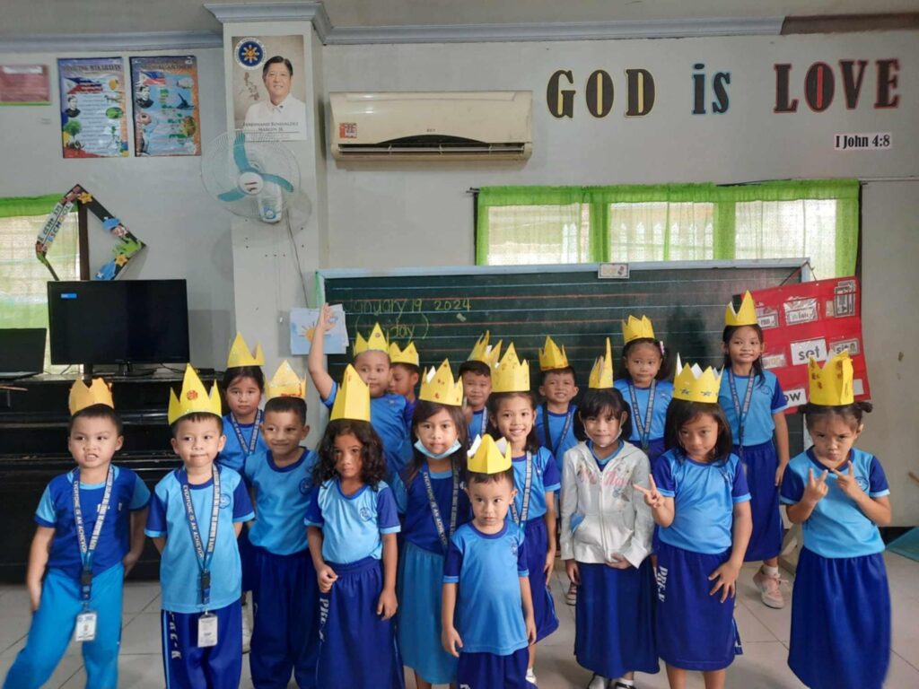 preschool students wearing blue PE uniform and crown on their heads at our Christian school in Mandaue